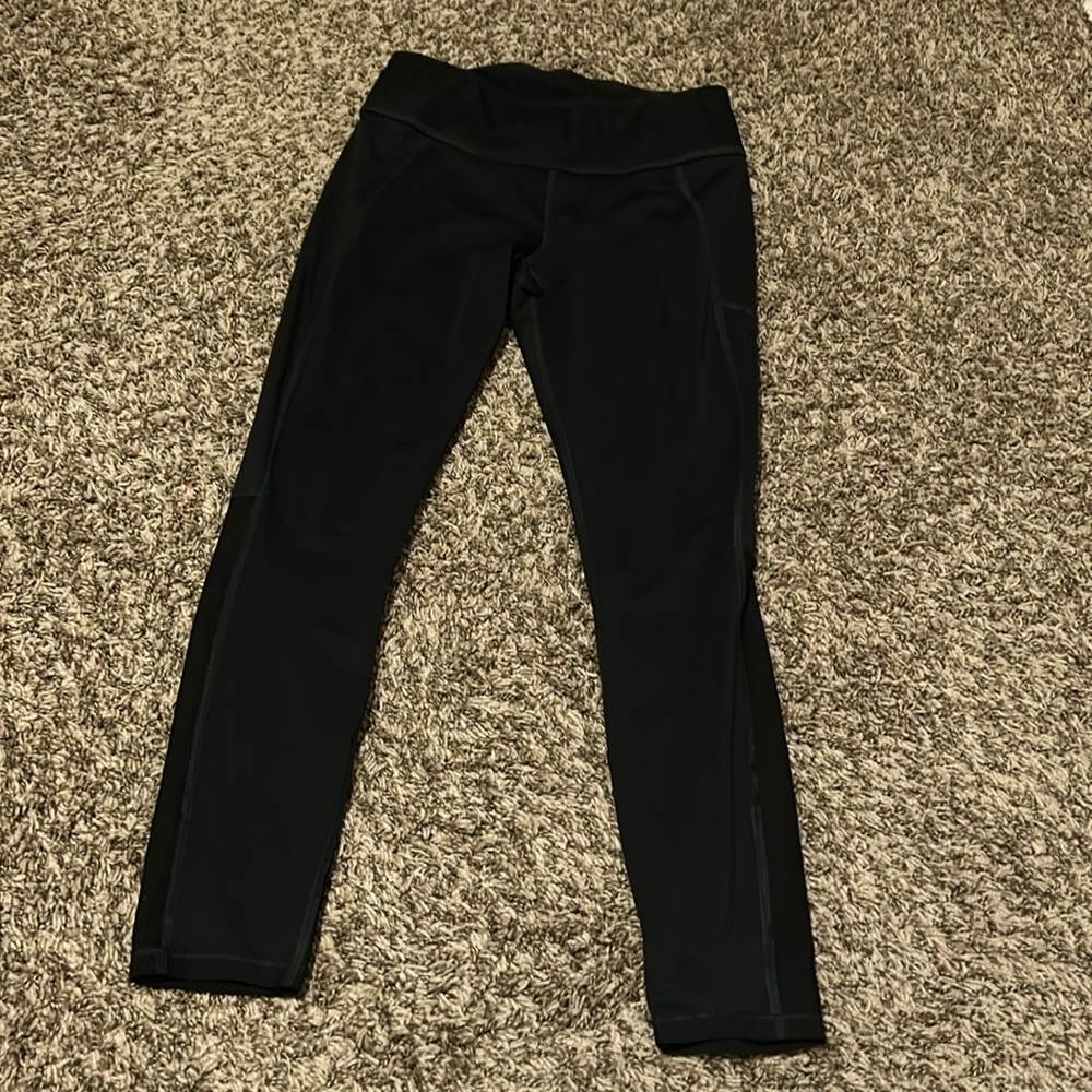 black athletic leggings. mesh on back of calves.